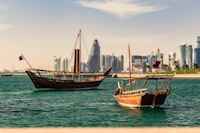 two ships on body of water near the city